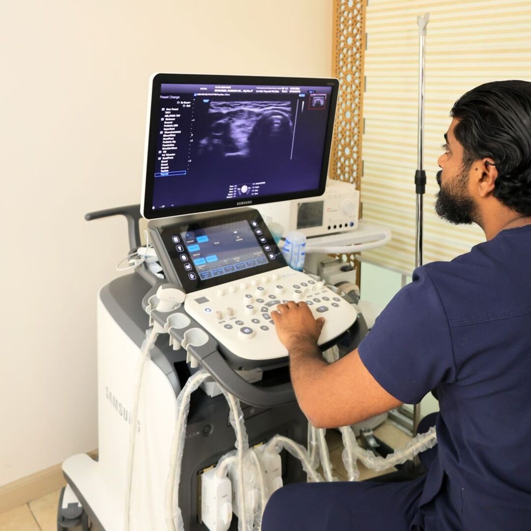 Consultant performing a high-resolution thyroid ultrasound on the clinic's Samsung scanner
